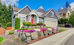 a large house with landscaping in front of it