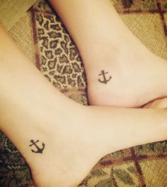 two people with small tattoos on their feet, one has an anchor and the other has a cheetah