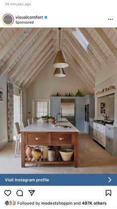 a kitchen with an island in the middle and lots of counter space on top of it