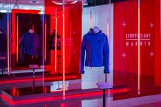 an exhibit with red and blue lights in the background, including mannequins