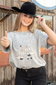 This grey t-shirt is the perfect shirt for your next rodeo, dance hall outing, or even movie night! The shirt features the phrase "Kick Rocks Cowboy" staggered with a pair of white cowboy boots and stars. Rodeo Dance, Kick Rocks, White Cowboy Boots, Grey T Shirt, Dance Hall, Gray Tshirt, Perfect Shirt, Movie Night