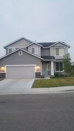 a large gray house with two garages