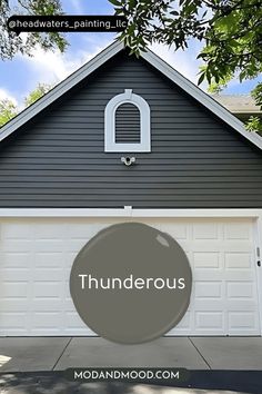 a house with the words thunderous painted on it's garage door and window