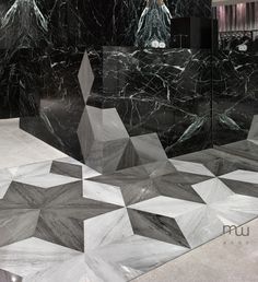 an artisticly designed bathroom with black and white marble