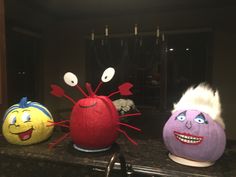 three stuffed toys sitting on top of a counter