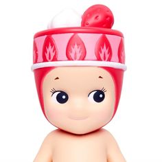 a small toy doll with a red hat on it's head and big eyes