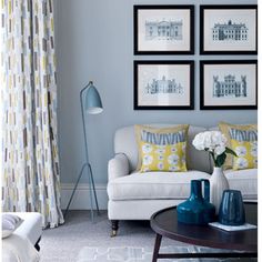 a living room filled with furniture and pictures on the wall