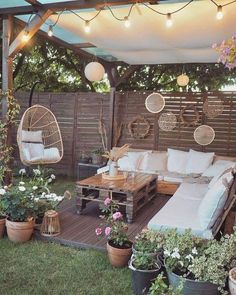 an outdoor patio is decorated with plants and furniture