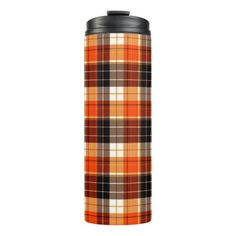 an orange and black plaid flask with a black lid on the bottom, in front of a white background