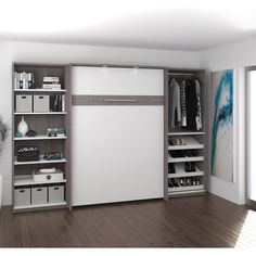 a white closet with shelves and drawers in it