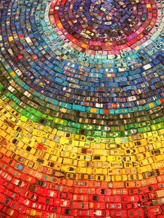 the cover of rainbow toy car installation made from 250 cars by christopher joseph on december 22, 2011