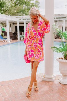 - Pack this cutie for your next vacay! A flirty deep-v neck and vibrant floral print create a look perfect for tropical style. A relaxed yet flattering silhouette that ends in a mini dress length hemline. - Unlined material with a cream, purple, and pink hued abstract floral print - A deep-v neckline - Short loose sleeves - An elastic waistline - A relaxed silhouette that ends in a mini dress length hemline Measurements S : Bust 28", Hip 32", Length 34", Sleeve Length 18.5", Waist 22-26". M : Bu Summer V-neck Beach Dress For Day Out, V-neck Tropical Print Beach Dress For Vacation, Flowy V-neck Beach Dress With Tropical Print, Tropical V-neck Mini Dress For Beach, Floral Print V-neck Dress For Beach Party, Chic V-neck Beach Dress For Poolside, Flowy Tropical V-neck Dress, Pink V-neck Dresses For Vacation, Flowy V-neck Tropical Dress