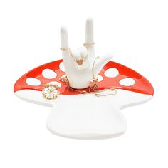 a red and white tray with a peace sign on it, holding a clock in the shape of a mushroom