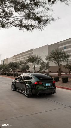 a black car parked in front of a building