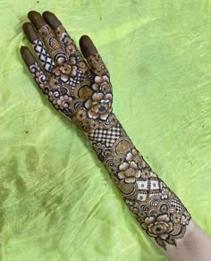 a woman's hand is decorated with hennap and flowers on the palm