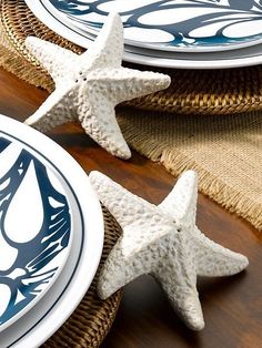 two starfish shaped plates sitting on top of a wooden table