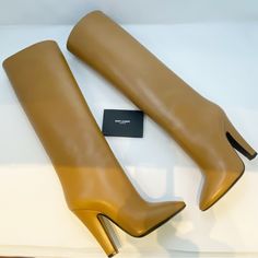 Saint Laurent Koller Camel Knee High Boot - Eur 36.5 (Fits Small) This Amazing Tall Boot Is Crafted From Smooth Calfskin Leather With An Almond Toe And Covered Heel. A Classic Pair That Can Elevate Any Outfit. Fits Small 4 1/4" (110mm) Heel 16" Shaft, 14" Shaft Circumference Pull-On Style Leather Upper, Lining And Sole Made In Italy New In Box Condition, No Dust Bag. Designer, Luxury, Formal, Going Out, Special Occasion, High Heels, Authentic, Shoes, Neutral, Minimalist, Trendy, Photoshoot, Clas Cone Heel Boots, Designer Beige Boots For Evening, Designer Beige Calf Leather Heels, Designer Beige Boots For Formal Occasions, Designer Beige Formal Boots, Luxury Beige Boots For Formal Occasions, Luxury Beige Formal Boots, Saint Laurent Chelsea Boots, Trendy Photoshoot