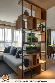 a living room filled with lots of furniture and plants on top of bookshelves