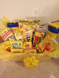 a yellow basket filled with snacks and drinks