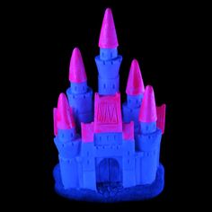 a blue and pink castle is shown on a black background in this image, it appears to be made out of plastic