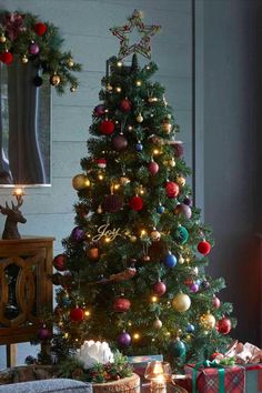 a decorated christmas tree with presents under it