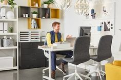 a man sitting at a desk in front of a computer