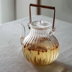 a glass tea pot sitting on top of a table