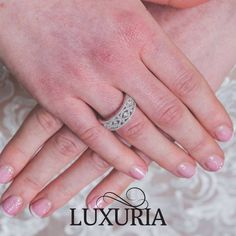 a close up of a person's wedding ring on their hand and the words luxury written below it