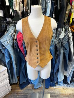 ♥ D E S C R I P T I O N ♥ Vintage 90s tan suede vest. Features a fitted design,and jean button rivets.  ♥ S I Z E & M E A S U R E M E N T S ♥ Measurements taken across while garment laying flat and unstretched. Double measurement to get the all around. Length: 22 in Chest: 17 in Waist: 15 in Size small  ♥ Authenticity Guarantee ♥ All items sold in our shop are 100% guaranteed authentic vintage or your money back. Fitted Fall Vest With Snap Buttons, Fitted Winter Vest With Snap Buttons, Casual Fitted Brown Vest, Sleeveless Vest With Snap Buttons For Fall, Fall Sleeveless Vest With Snap Buttons, Fitted Sleeveless Denim Vest For Fall, Fitted Denim Vest With Buttons For Fall, Fitted Denim Vest With Button Closure For Fall, Fitted Western Style Winter Vest