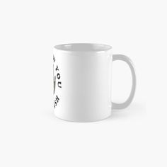 a white coffee mug with black writing on the front and bottom, sitting against a white background