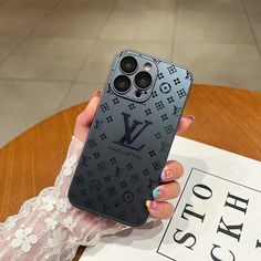 a woman holding up her louis vuitton phone case in front of the camera