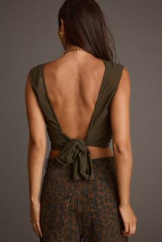 It's easy to say we’re obsessed with the Mila Olive Set, the newest color way of the Mila Set. This olive beauty features an open back and high neck, making it a must-have addition to your wardrobe. This top pairs perfectly with the Mila Olive Maxi Skirt and an olive martini in hand. Trust us, you’re going to need both colors—the olive and the leopard—to keep your style game strong all season long. Stretch Backless Top With Tie Back, Stretch Tie Back Backless Top, Stretch Tie-back Backless Top, Olive Stretch Top For Summer, Olive Stretch Summer Tops, Summer Stretch Olive Tops, Chic Summer Tops With Ruched Back, Stretchy Olive Summer Tops, Chic Low-back Tops For Party