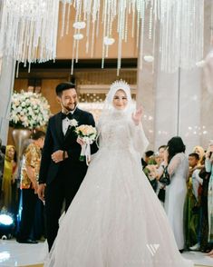 the bride and groom are walking down the aisle