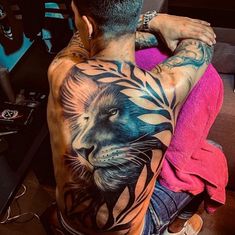 a man with a lion tattoo on his back