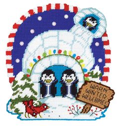 a cross stitch christmas card with penguins in front of an igloose