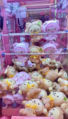 there are many stuffed animals on display in the store