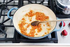 a pan filled with food sitting on top of a stove next to a burner