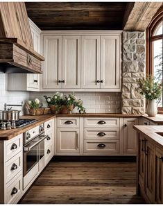 a kitchen with white cabinets and wood floors, an oven and counter tops is shown