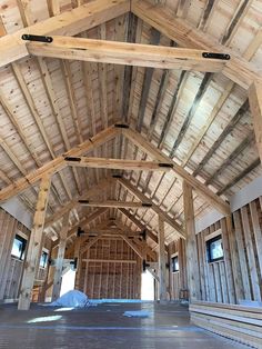 the inside of a large wooden building with wood beams on it's walls and floor