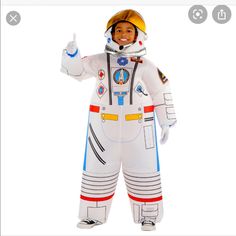 a man in an astronaut costume giving the thumbs up