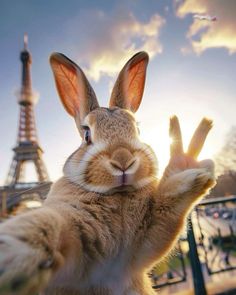 a rabbit raising its hand in front of the eiffel tower