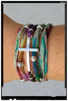 Silver Cross Wrap Bracelet with Artistic Pallet Sari Silk. Colorful Silk with Silver accent beads and Connectors. *Custom Orders Welcome* Gift Box, Extras, etc... May be purchased in the Ala Carte Listing. https://www.etsy.com/listing/286913011/ala-carte-ordersadd-onsextras-stainless Silk Wrap Bracelets, Zodiac Rings, Sari Silk, Silk Wrap, Gold Cross, Religious Gifts, Braided Bracelets, Silver Cross, Silver Accents