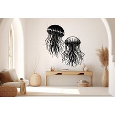 two black jellyfish wall decals in a living room with white walls and furniture