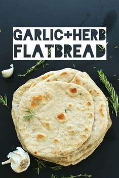 garlic and herb flatbread on a black surface