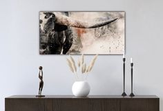 an abstract painting hangs on the wall above a dresser