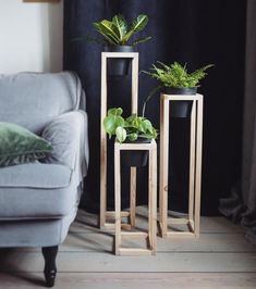 two wooden plant stands with plants in them