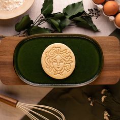 a cookie is sitting on a tray next to some eggs