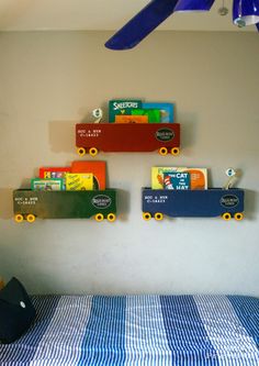 there are three skateboards mounted to the wall above a bed with blue and white checkered bedspread