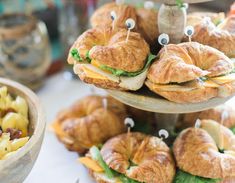 there are sandwiches and other food items on the table for desserts to be eaten