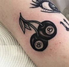 a tattoo with two black and white billiards on it